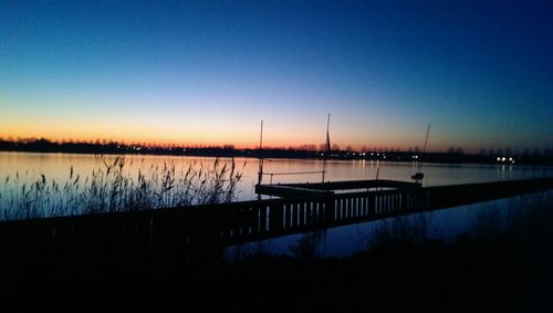 Scenic view of calm lake at sunset