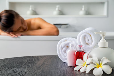 Midsection of shirtless man in bathtub at home