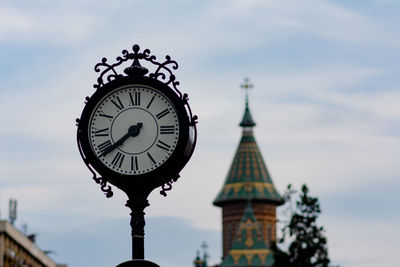 Low angle view of clock tower against sky