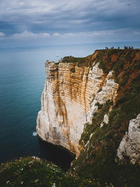 Rock formations by sea against sky