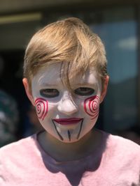 Close-up portrait of boy with make-up