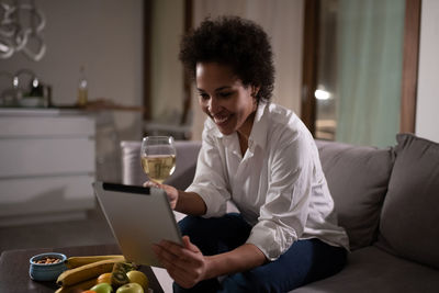 Happy mixed race woman during online date