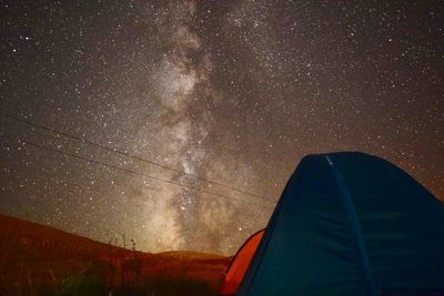 Low angle view of tent against star field at night
