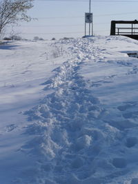 Snow covered field against sky