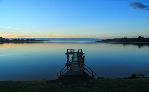 Scenic view of lake against sky at sunset