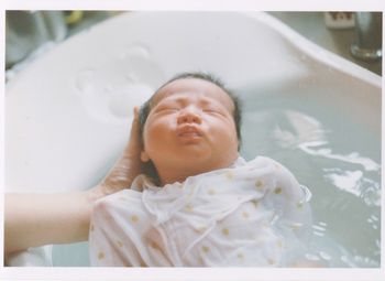 PORTRAIT OF BABY BOY IN THE BATHROOM