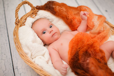 Portrait of cute baby lying down on bed