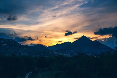 Scenic view of mountains against cloudy sky