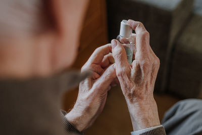 Midsection of man spraying sanitizer