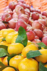 Oranges and apples for sale at market stall