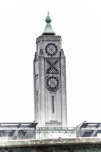 Low angle view of clock tower against sky in city