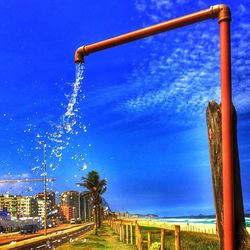 Street light against blue sky