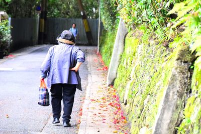 Senior woman walking along street