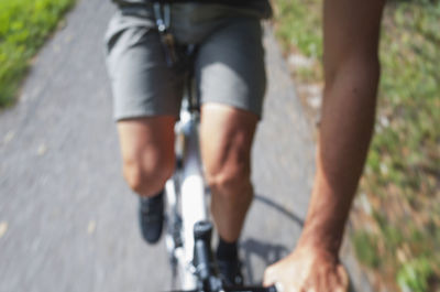Low section of man walking on road