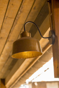 Low angle view of illuminated pendant lights hanging on ceiling