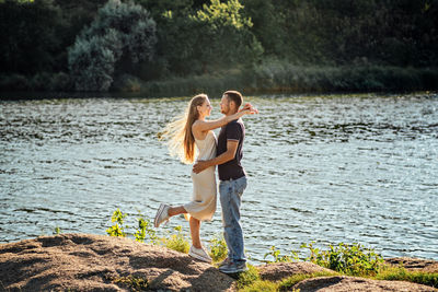 Declarations of love, candid couple in love holding hands on nature background.