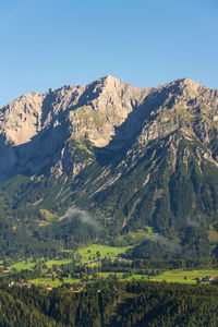 Scenic view of snowcapped mountains against clear sky