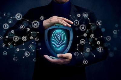 Digital composite image of businessman with fingerprint security system