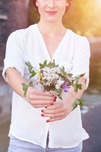 Close-up portrait of a woman holding flower