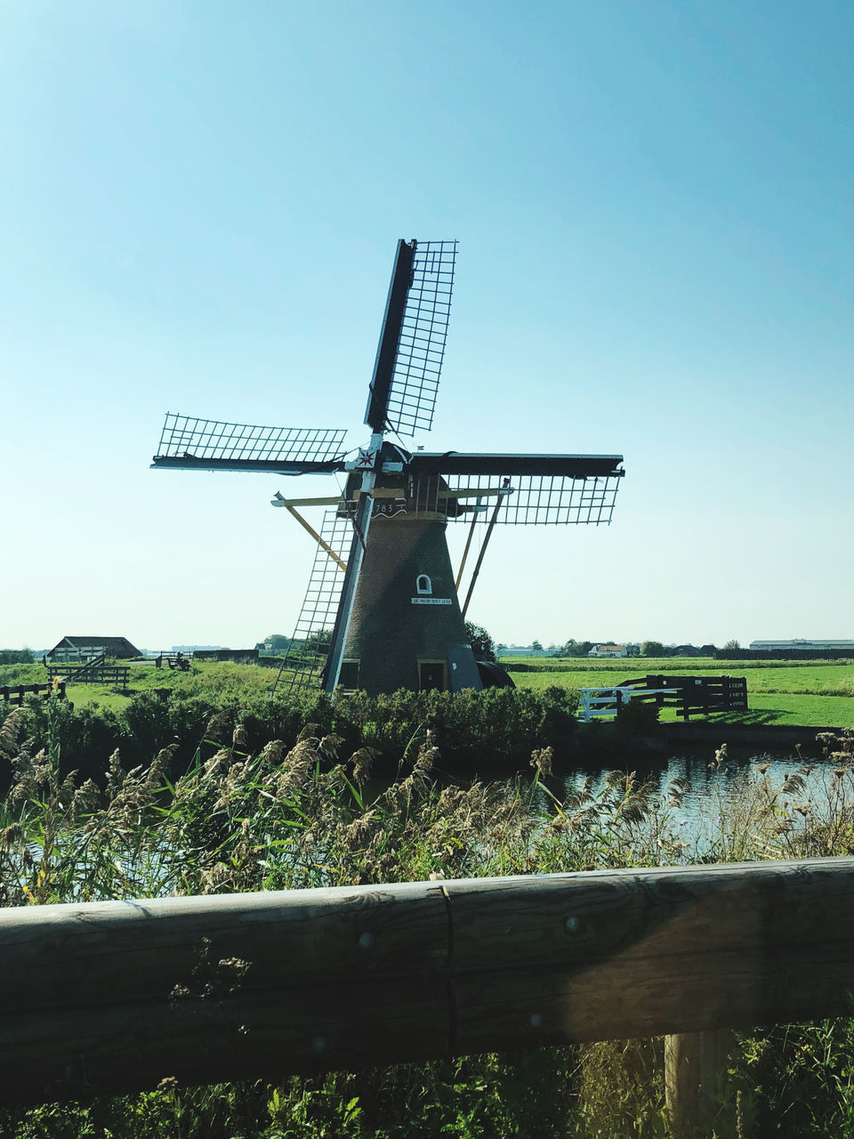 WINDMILL ON FIELD AGAINST SKY