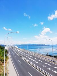 Road by sea against sky