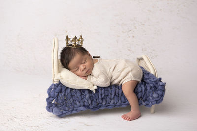 Portrait of baby sitting on sofa at home