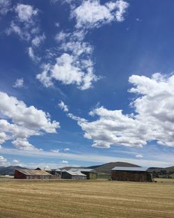 Barns on field against sky