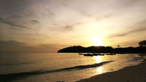 View of calm beach at sunset