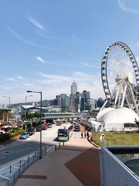 Ferris wheel in city against sky, city land mark view in hong kong 