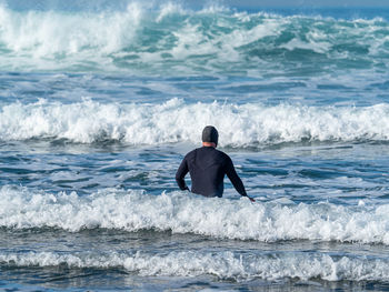 Rear view of man on beach