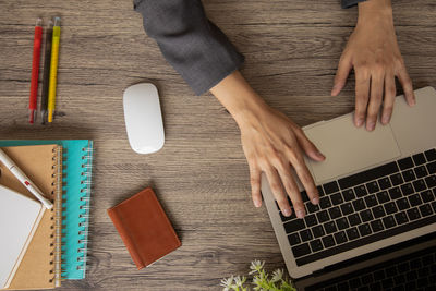 High angle view of woman using laptop on table