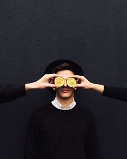 Boy wearing mask standing in front of wall