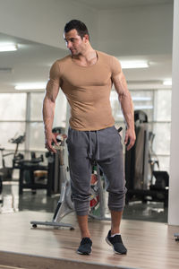 Muscular man standing in gym