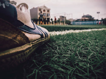 Close-up of shoes on field