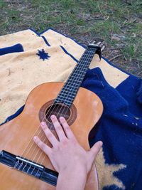 Midsection of person playing guitar