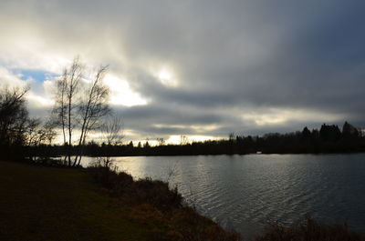 Scenic view of river against sky at sunset