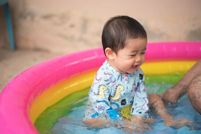 Cute girl sitting in bathtub outdoors