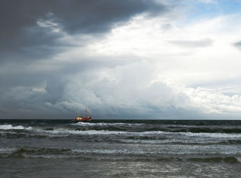 Scenic view of sea against cloudy sky