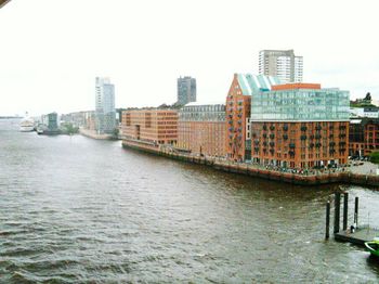 River in city against clear sky