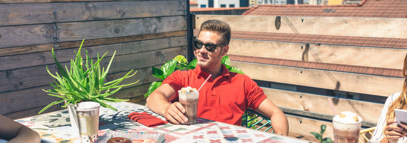 Man sitting at restaurant on sunny day