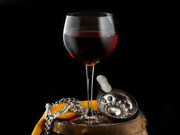 Close-up of wine glass against black background