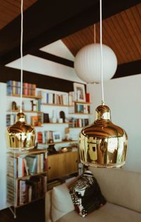 Close-up of illuminated lamp hanging on table at home