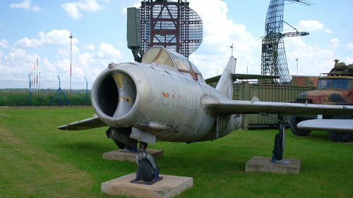 Airplane on field against sky