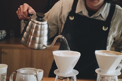 Midsection of man pouring making coffee