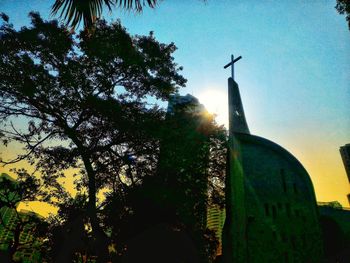 Low angle view of silhouette statue against sky