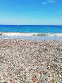 Scenic view of beach against blue sky