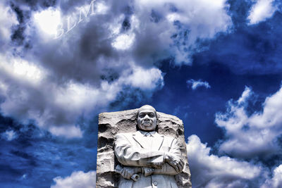 Low angle view of statue against blue sky