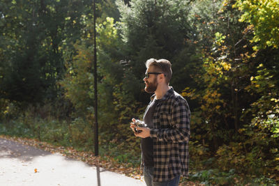 Full length of woman standing in forest