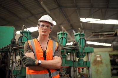 Portrait of young man working in factory