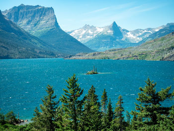 Scenic view of sea and mountains against sky